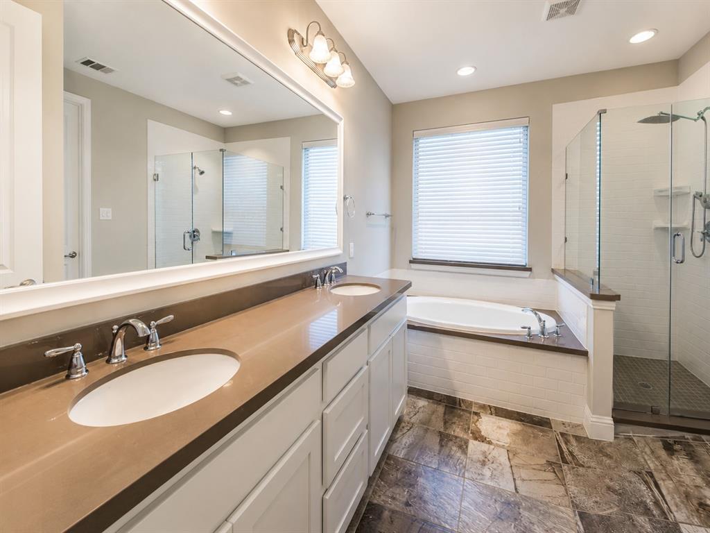 6209 Cupleaf Road Flower Mound, TX 76226 - Photo 23 of 29 Dual vanity with undermount sinks and chrome fixtures, framed mirror, built-in soaking tub, glass-enclosed shower with subway tile surround, and large format floor tiling