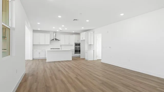 a view of kitchen with wooden floor and electronic appliances