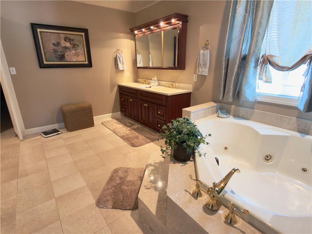 4982 Abbey Road Coplay, PA 18037 - Photo 38 of 55 Tiled flooring and a corner soaking tub define this master bathroom design.
