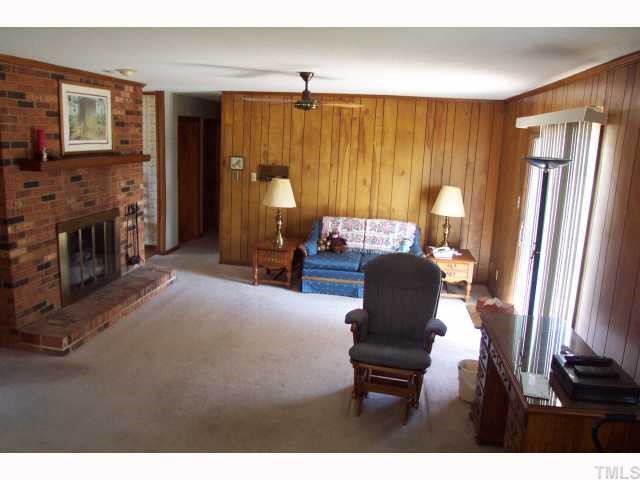 319 Sherron Road Durham, NC 27703 - Photo 5 of 6 a living room with furniture and a fireplace
