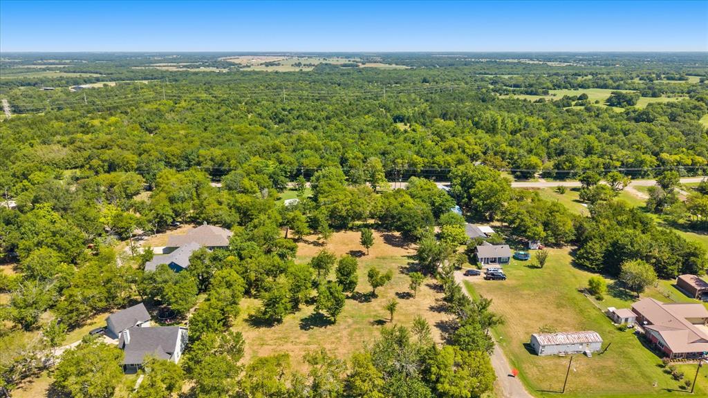 405 3rd Street Commerce, TX 75428 - Photo 16 of 26 an aerial view of residential houses with outdoor and green space