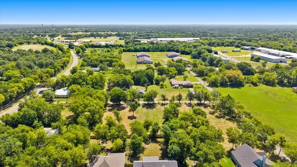 an aerial view of residential building with outdoor space and trees