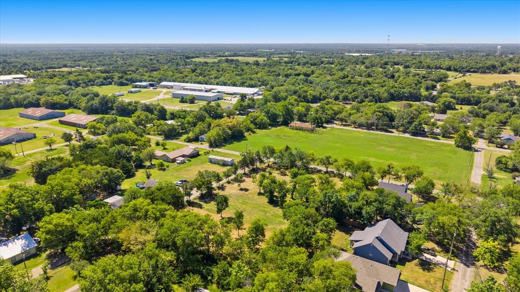405 3rd Street Commerce, TX 75428 - Photo 20 of 26 an aerial view of residential building with outdoor space and trees