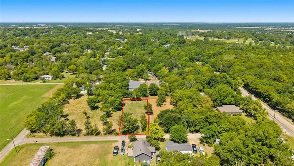 an aerial view of residential houses with yard