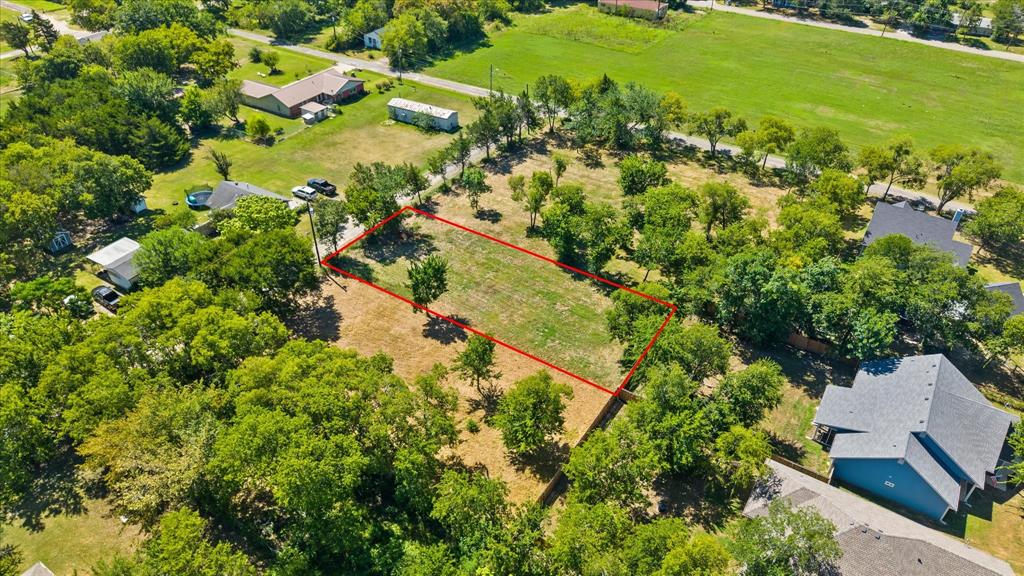 405 3rd Street Commerce, TX 75428 - Photo 9 of 26 an aerial view of residential houses with outdoor space and trees all around