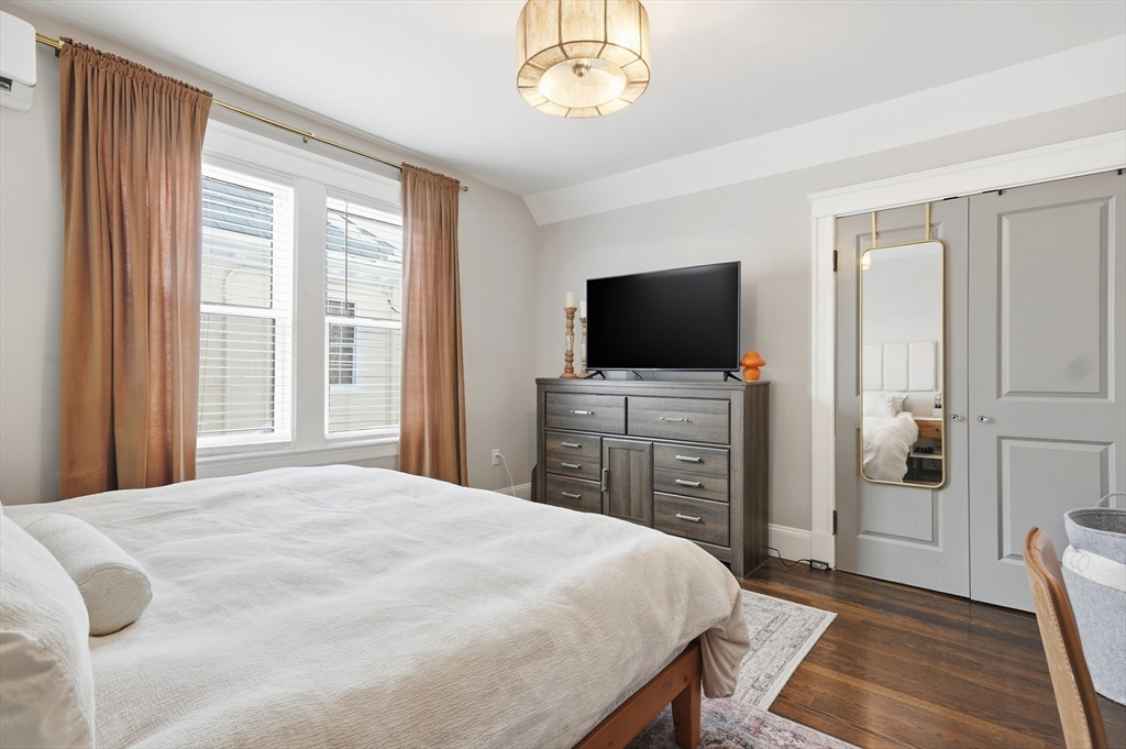 13 Roslyn Street, Unit 2 Salem, MA 01970 - Photo 15 of 26 a bedroom with a bed and a flat tv screen on dresser