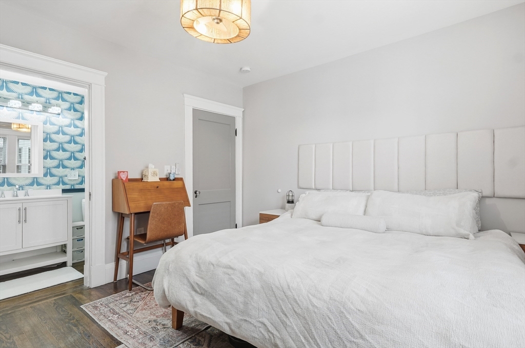 13 Roslyn Street, Unit 2 Salem, MA 01970 - Photo 16 of 26 a bedroom with a bed and wooden floor