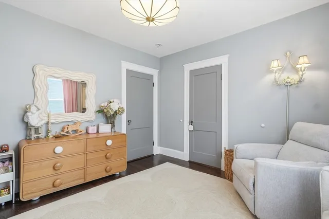 a bedroom with a bed and a potted plant