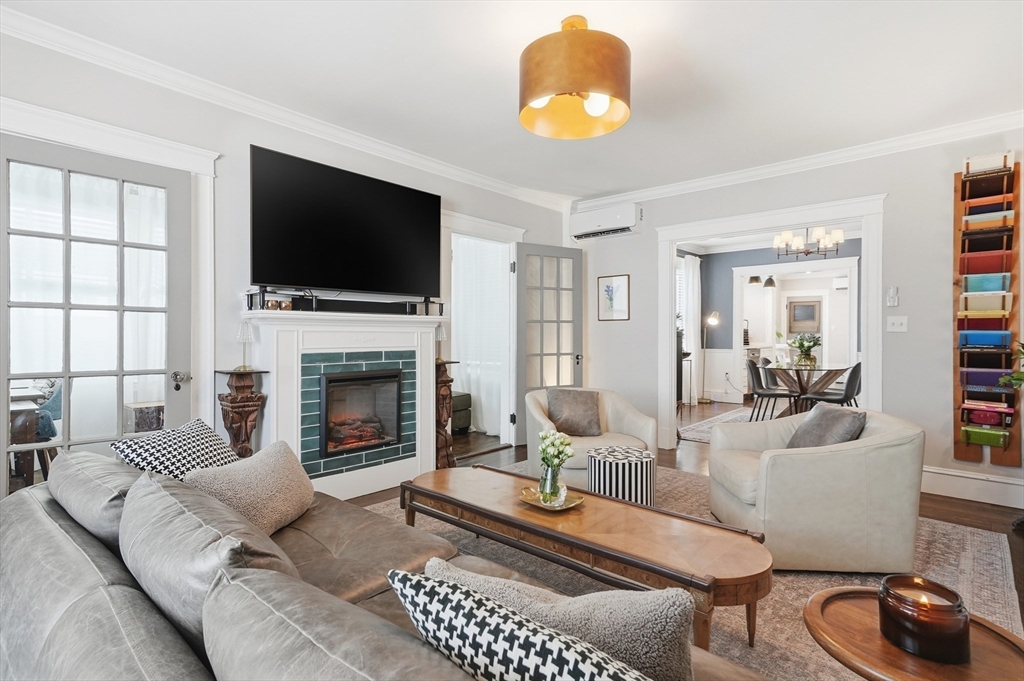 13 Roslyn Street, Unit 2 Salem, MA 01970 - Photo 4 of 26 a living room with furniture a flat screen tv and a fireplace