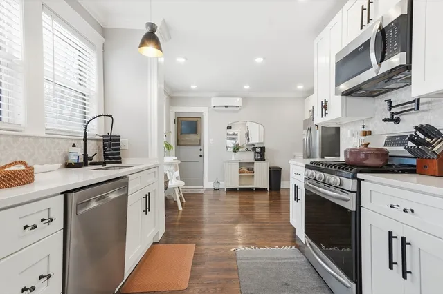a kitchen with stainless steel appliances granite countertop a stove a microwave and cabinets