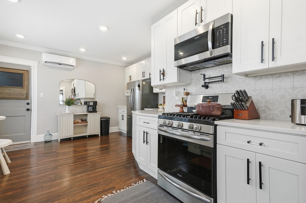 13 Roslyn Street, Unit 2 Salem, MA 01970 - Photo 7 of 26 a kitchen with stainless steel appliances granite countertop a stove a microwave and cabinets