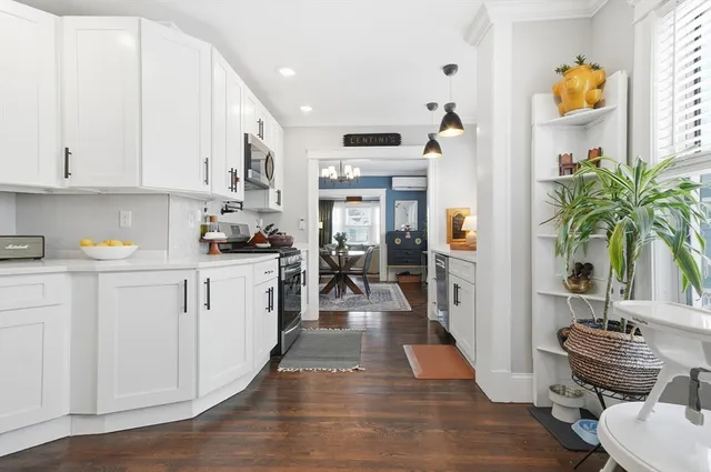 a kitchen with stainless steel appliances granite countertop a sink and cabinets