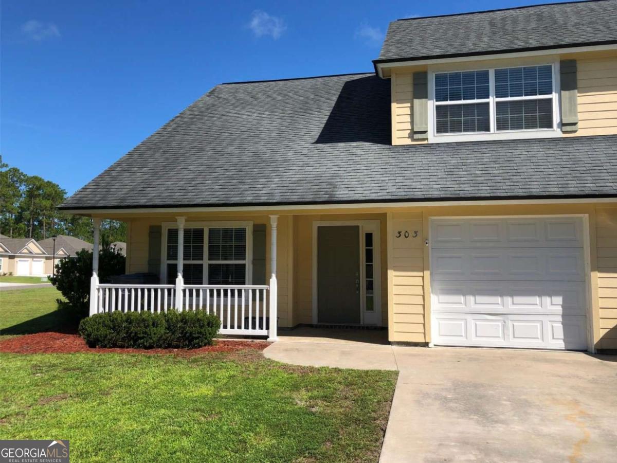 303 Gary Circle St. Marys, GA 31558 - Photo 1 of 42 a front view of a house with a yard