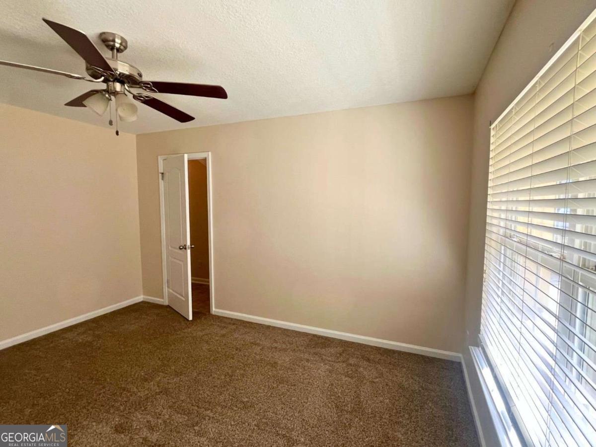 303 Gary Circle St. Marys, GA 31558 - Photo 17 of 42 an empty room with a window and a fan