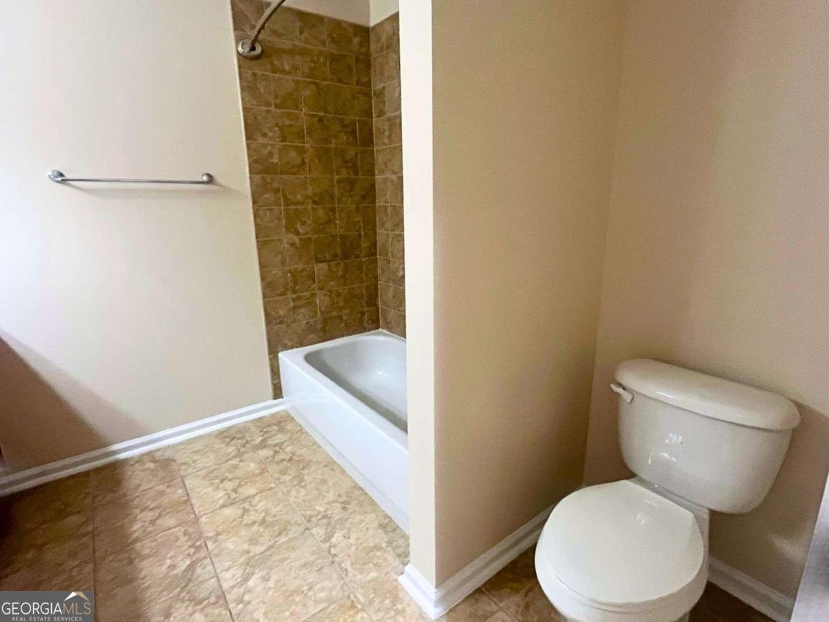 303 Gary Circle St. Marys, GA 31558 - Photo 24 of 42 a bathroom with a toilet and a shower