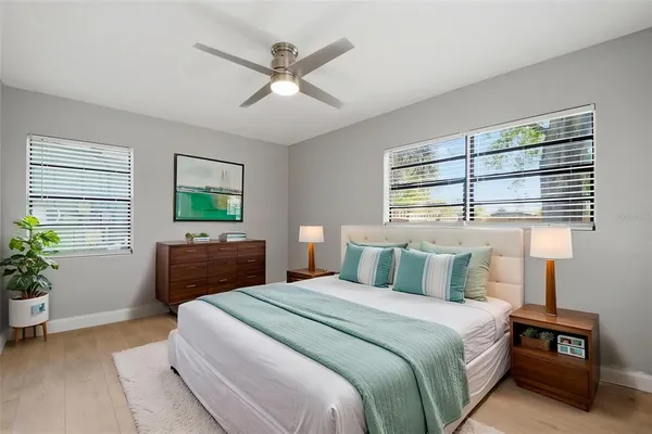 a large kitchen with stainless steel appliances granite countertop a stove top oven a refrigerator a sink and dishwasher with white cabinets