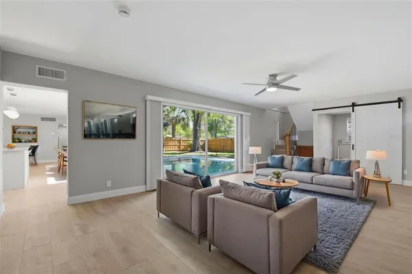 a kitchen with stainless steel appliances a stove a sink dishwasher a refrigerator and a oven with wooden floor