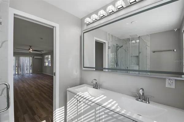 a view of a room with window and ceiling fan