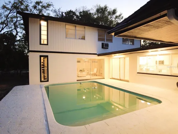 a view of a swimming pool with a back yard