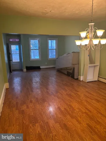a view of a livingroom with furniture and chandelier fan