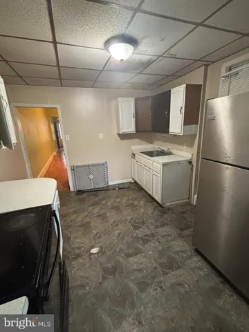 a kitchen with refrigerator and stove