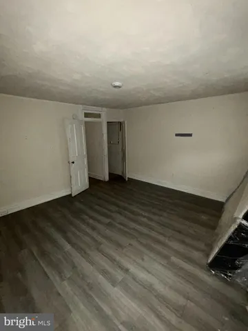 a view of an empty room and wooden floor