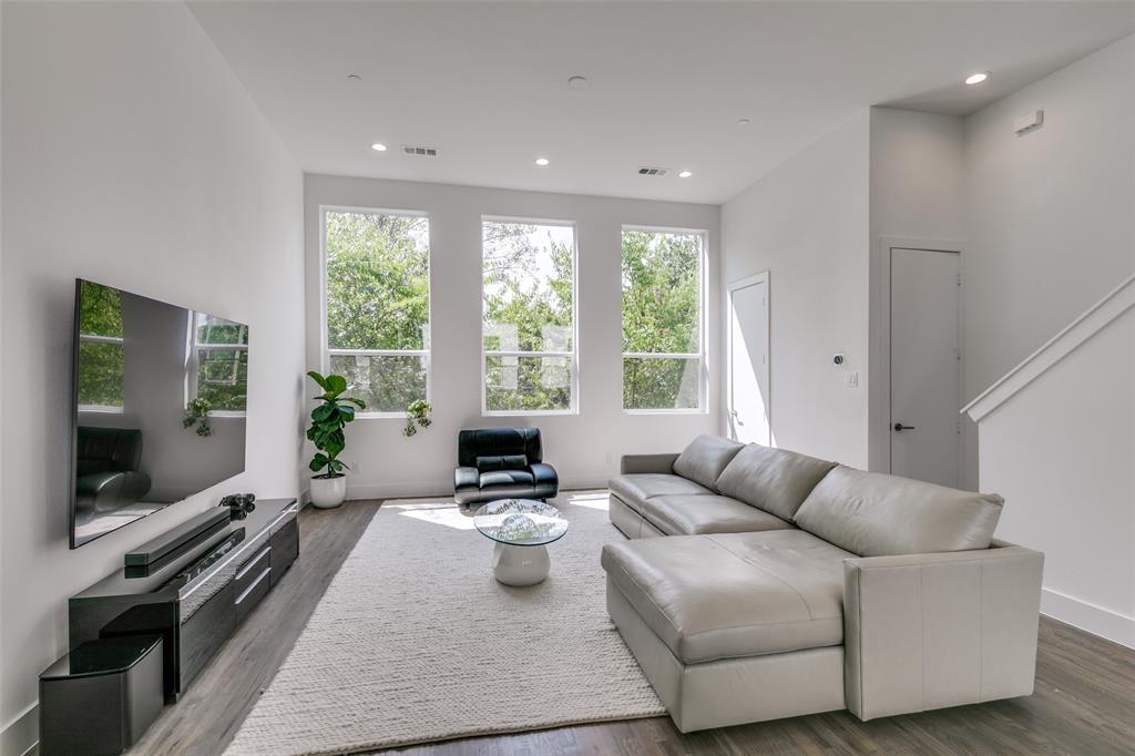 2908 Raleigh Street, Unit 204 Dallas, TX 75219 - Photo 15 of 25 a living room with furniture and a flat screen tv