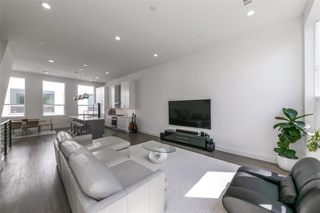 2908 Raleigh Street, Unit 204 Dallas, TX 75219 - Photo 17 of 25 a living room with furniture and a flat screen tv
