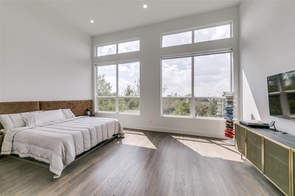 2908 Raleigh Street, Unit 204 Dallas, TX 75219 - Photo 19 of 25 a bedroom with a bed and a large window