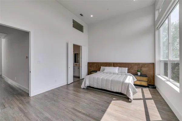 a bedroom with a bed and large window