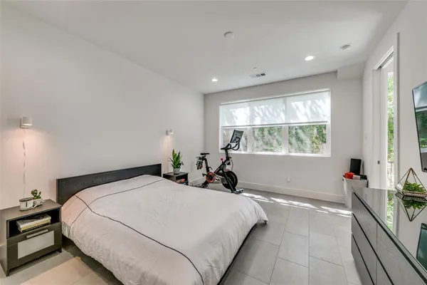 a bed room with a bed and a large window