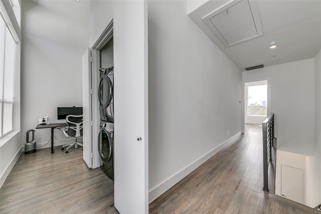 2908 Raleigh Street, Unit 204 Dallas, TX 75219 - Photo 7 of 25 a view of a hallway with wooden floor and a living room