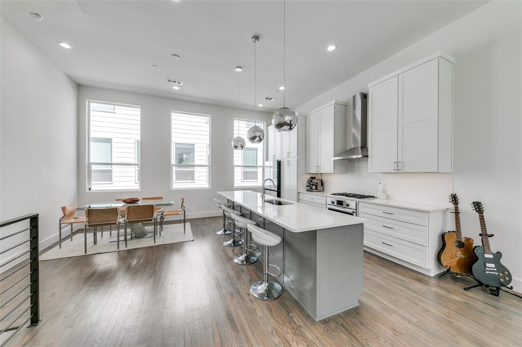 2908 Raleigh Street, Unit 204 Dallas, TX 75219 - Photo 9 of 25 a kitchen that has a lot of cabinets a sink and a stove in it
