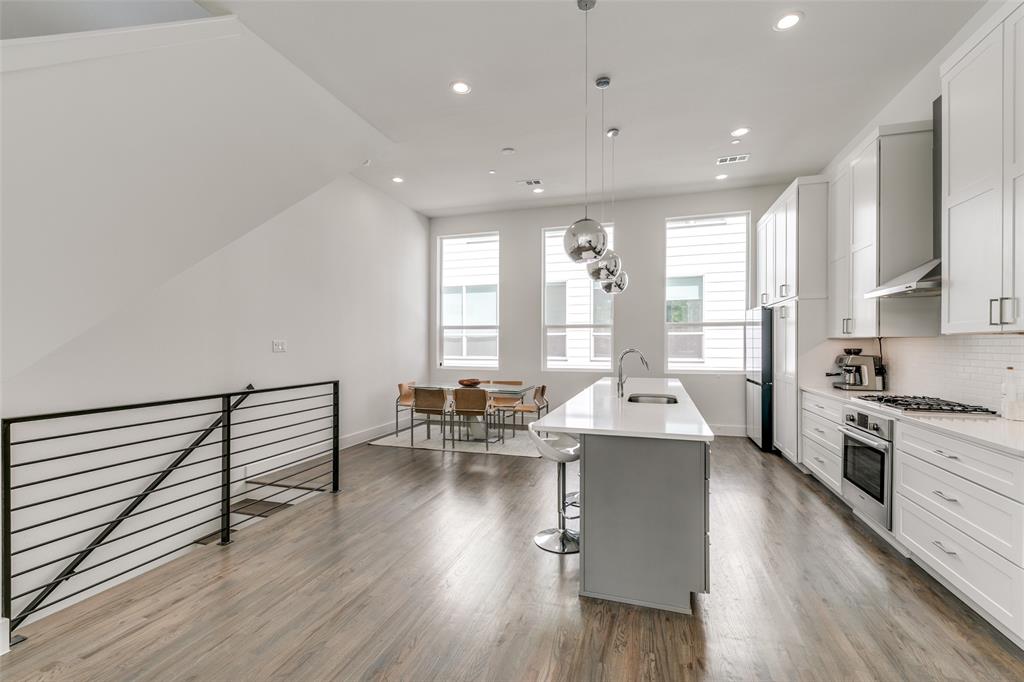 2908 Raleigh Street, Unit 204 Dallas, TX 75219 - Photo 10 of 25 a living room with furniture and large windows