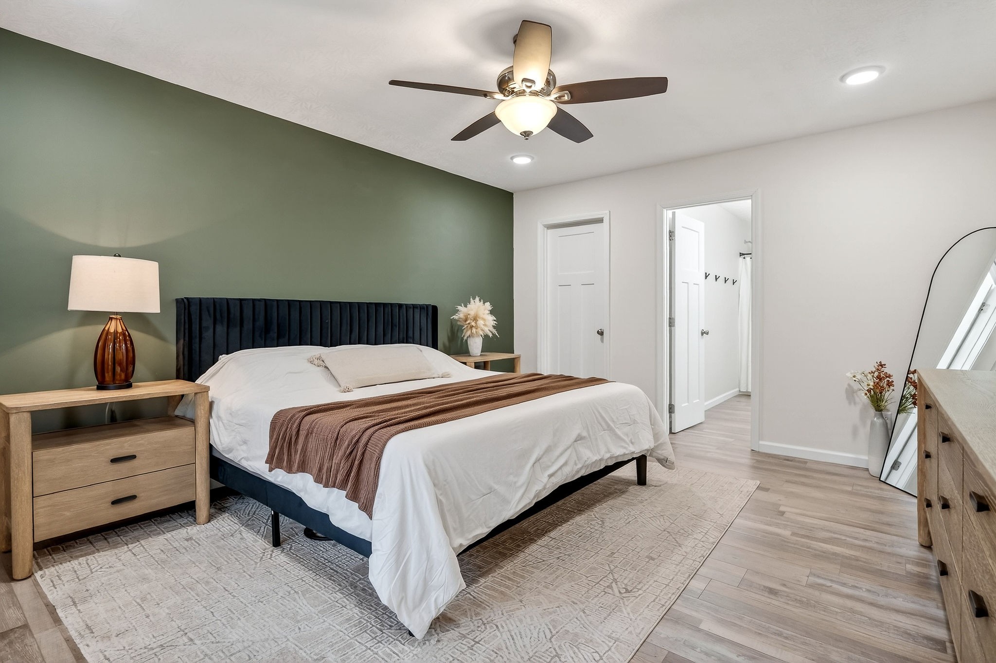 217 Peach Street Baxter, TN 38544 - Photo 13 of 39 a spacious bedroom with a bed and a chandelier