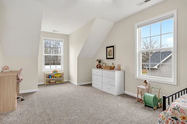 a bed room with a bed and a window