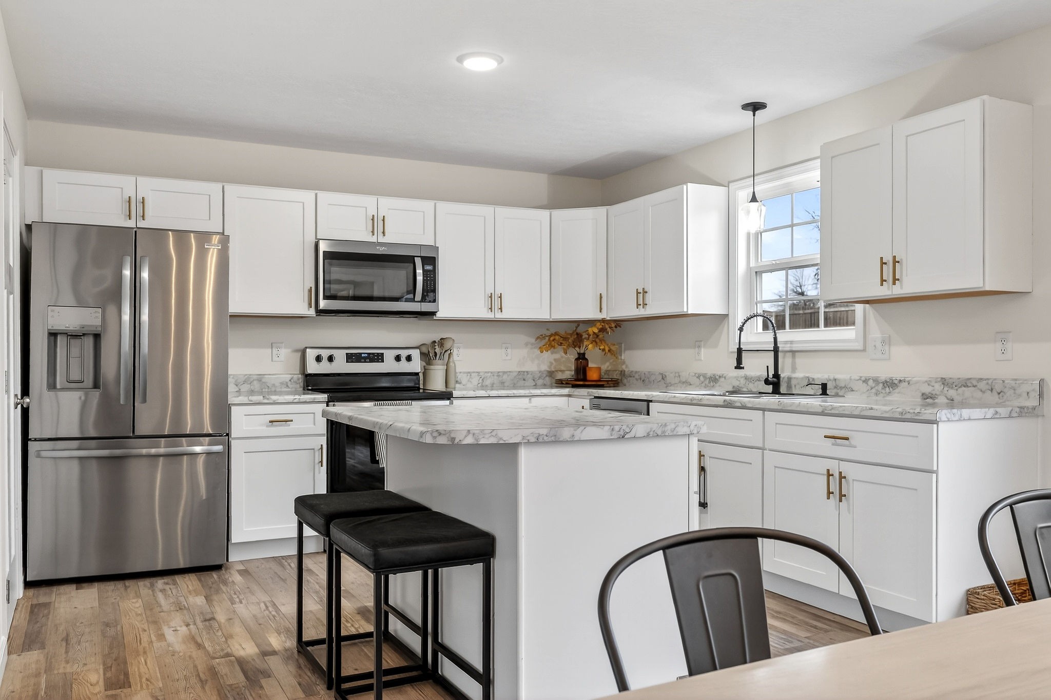 217 Peach Street Baxter, TN 38544 - Photo 6 of 39 a kitchen with stainless steel appliances granite countertop a refrigerator a stove a sink dishwasher and a refrigerator with wooden floor