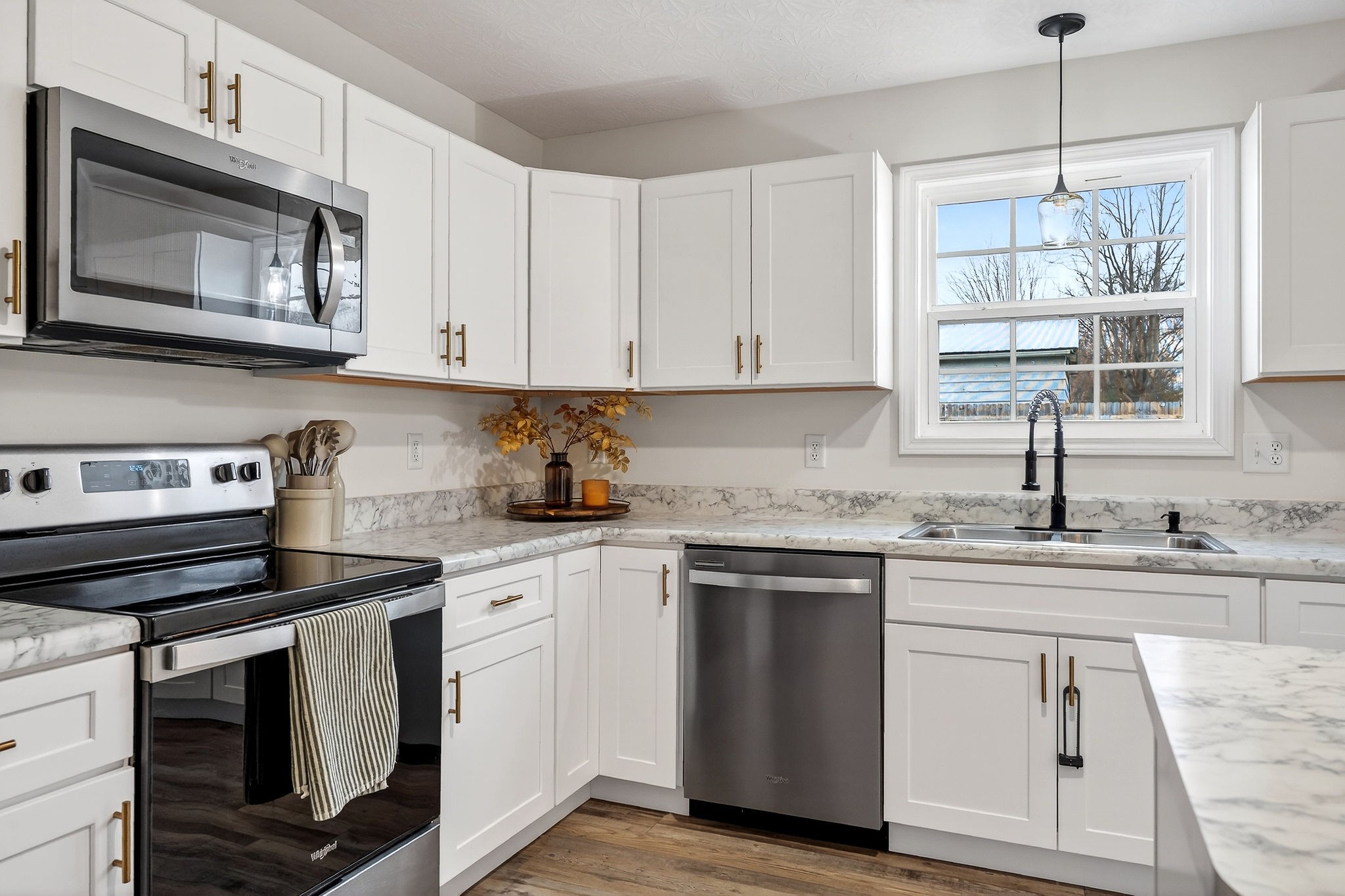 217 Peach Street Baxter, TN 38544 - Photo 8 of 39 a kitchen with cabinets appliances a sink and a window