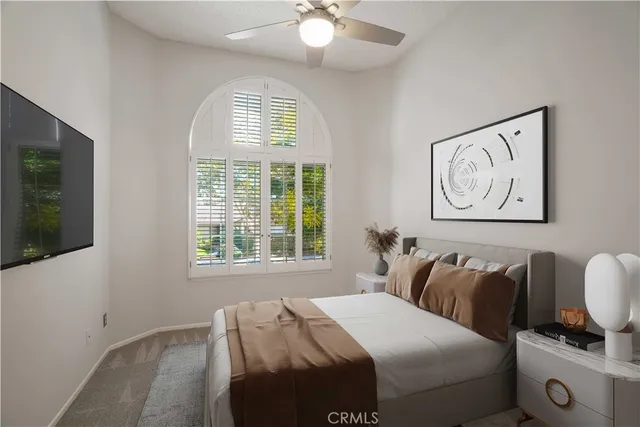 a bedroom with bed and cupboard