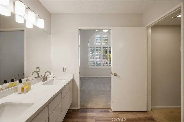 a bathroom with a double vanity sink a mirror and a shower