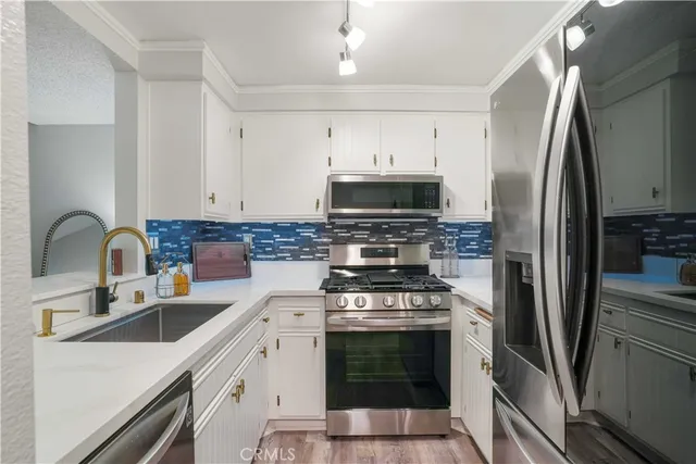 a kitchen with a sink cabinets and wooden floor