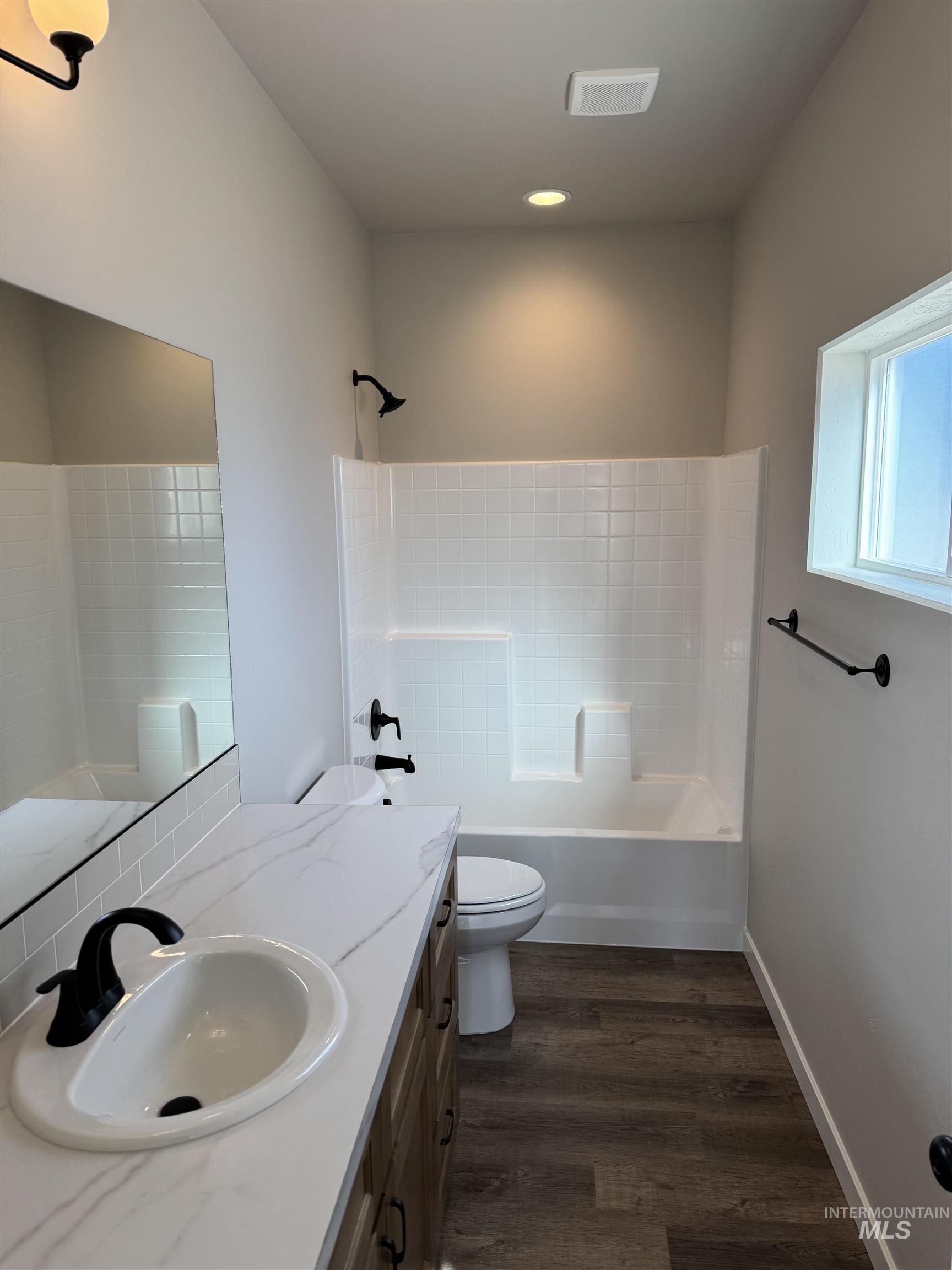 2064 Harrison Street South Twin Falls, ID 83301 - Photo 16 of 29 Bathroom featuring vanity, bathtub / shower combination, and dark wood-style floors