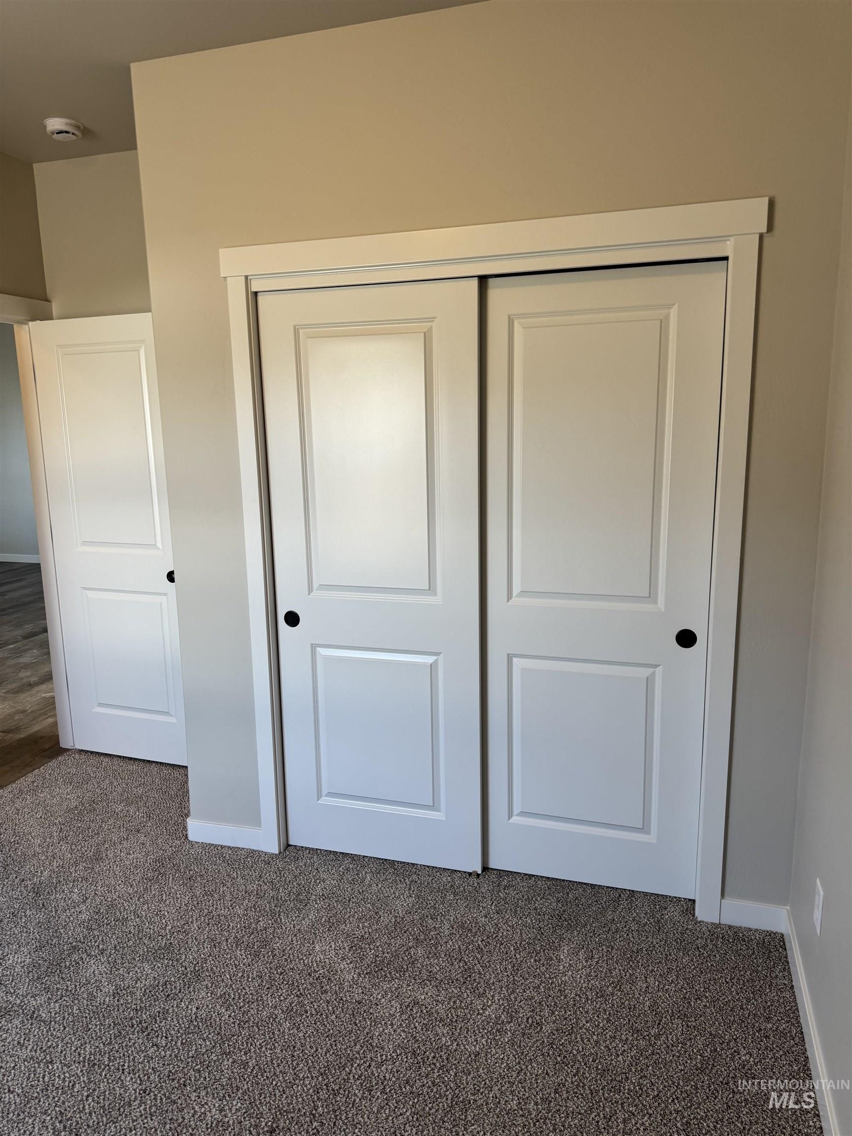 2064 Harrison Street South Twin Falls, ID 83301 - Photo 20 of 29 Unfurnished bedroom featuring a closet and dark colored carpet