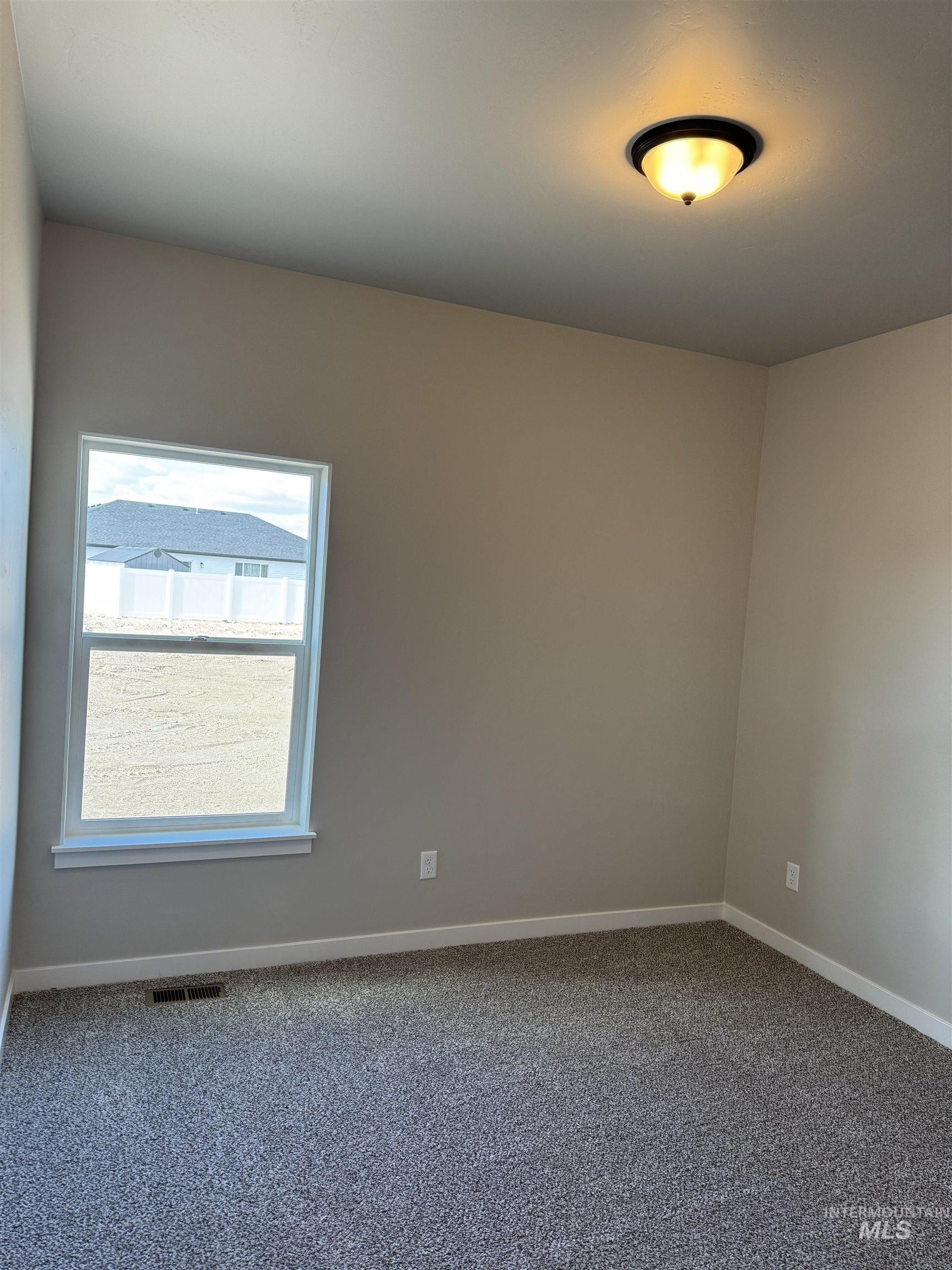 2064 Harrison Street South Twin Falls, ID 83301 - Photo 21 of 29 Carpeted empty room featuring baseboards