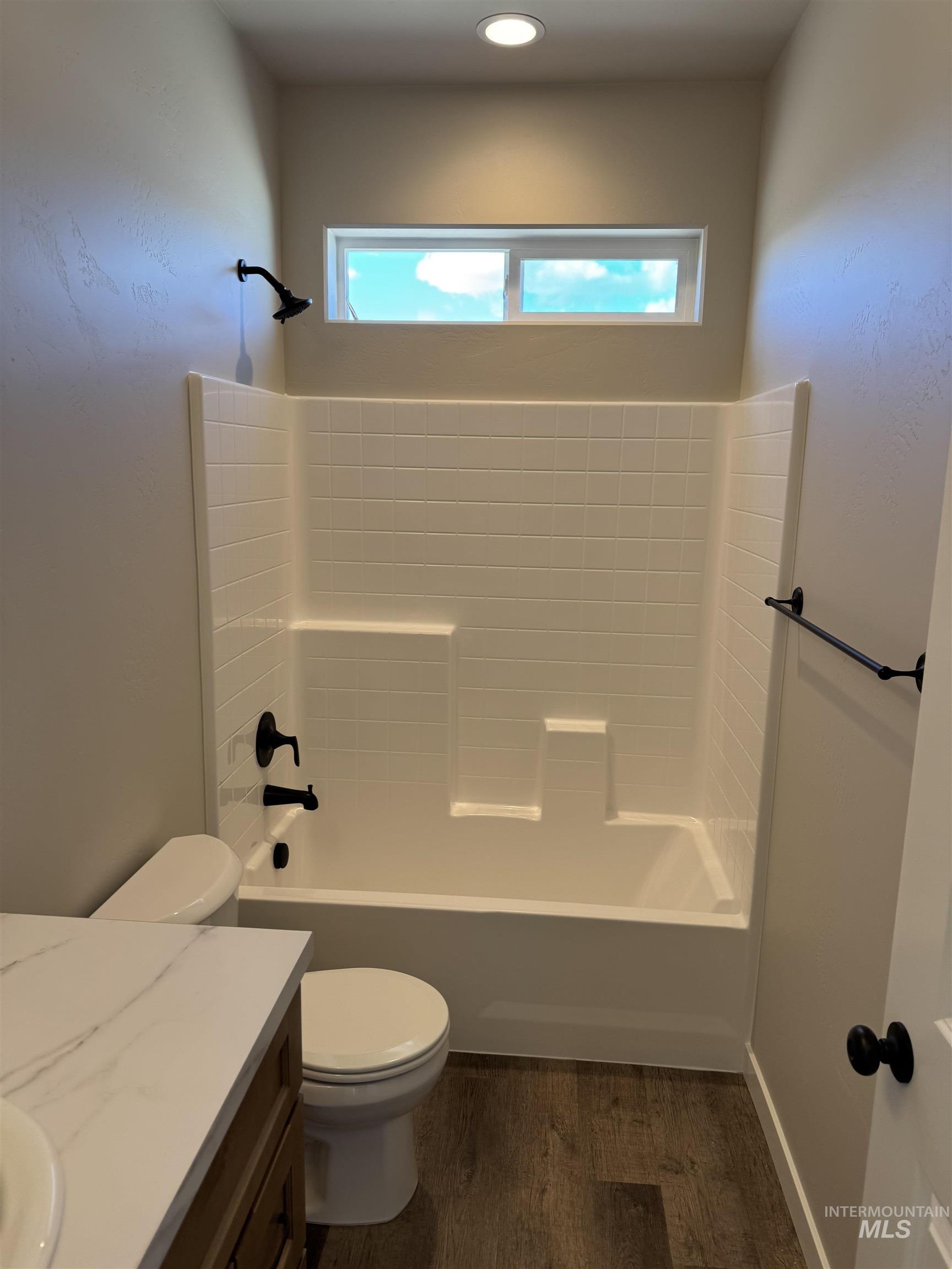 2064 Harrison Street South Twin Falls, ID 83301 - Photo 22 of 29 Bathroom with vanity, washtub / shower combination, and dark wood-type flooring