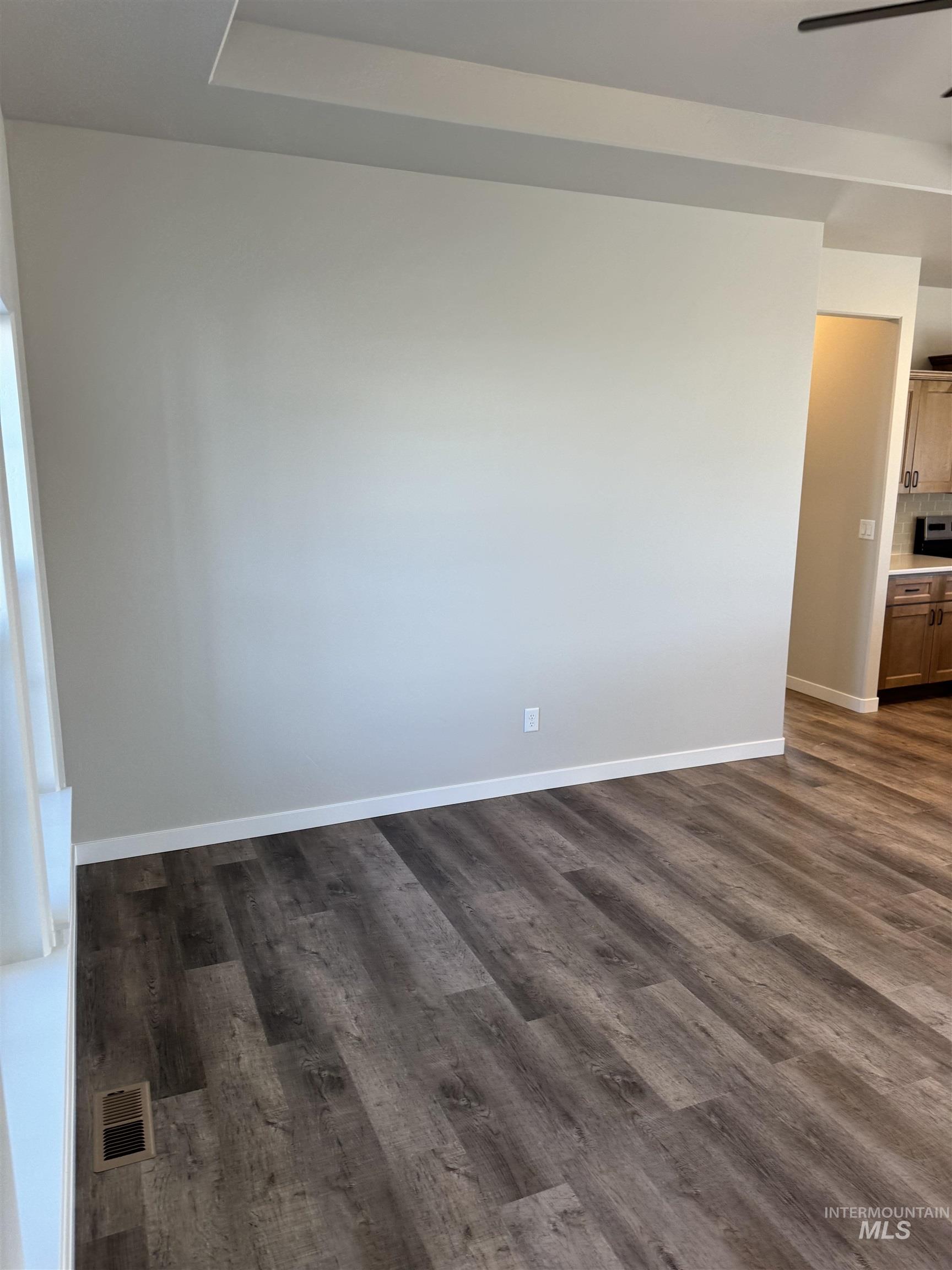 2064 Harrison Street South Twin Falls, ID 83301 - Photo 5 of 29 Empty room featuring dark wood-style flooring and a ceiling fan