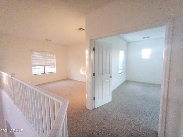 a view of a hallway with windows