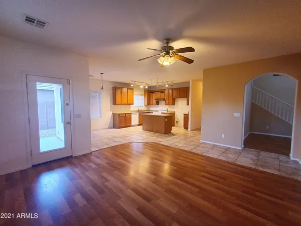 a view of a livingroom with a kitchen and wooden floor