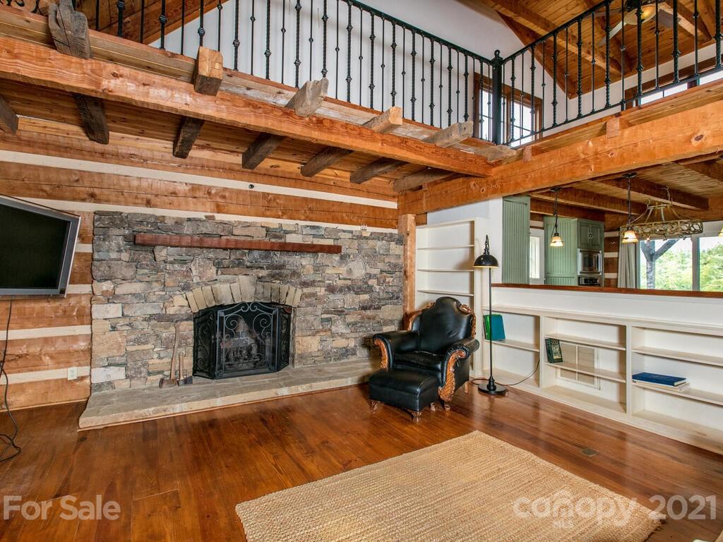 723 North Highland Road, Unit 9 10 11 Mill Spring, NC 28756 - Photo 11 of 46 a living room with furniture a fireplace and a piano