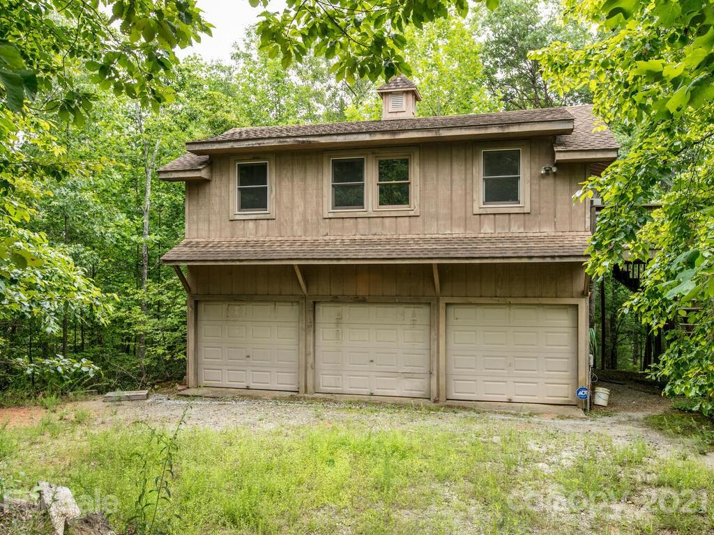 723 North Highland Road, Unit 9 10 11 Mill Spring, NC 28756 - Photo 14 of 46 a front view of a house with garage